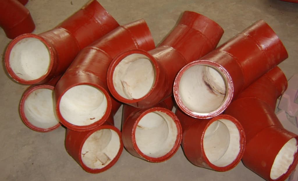 Abrasion resistant lined pipe elbows